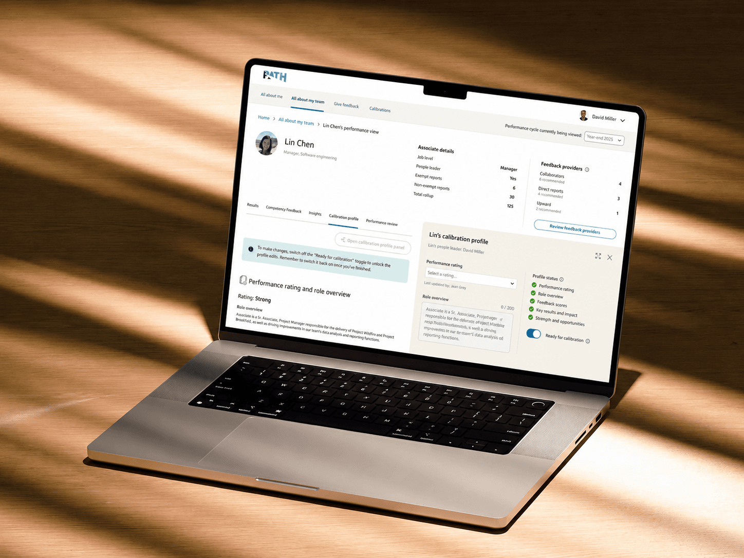 People Leader Redesign: laptop mockup showing the 50/50 performance evidence and calibration profile workspace